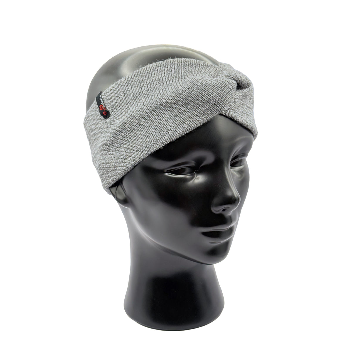 Puppenkopf trägt ein Stirnband für Damen aus Merinowolle in Grau mit Woolona Etikett