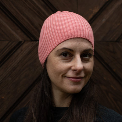 Frau mit einer pink farbenen Merinomütze. 