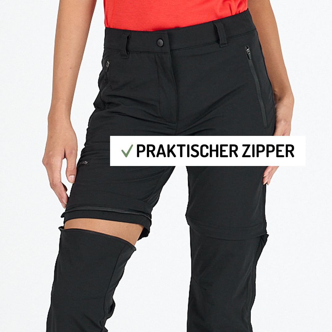 Frau zeigt die Funktion einer Zip Off Hose in der Farbe schwarz. 
